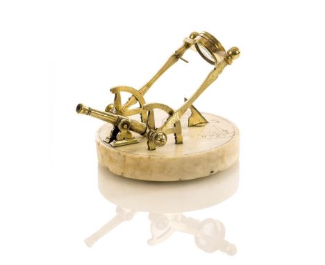 A 19TH-CENTURY MARBLE AND BRASS NOON DAY CANNON DIAL, with white marble base incised with scales divided from 7-12 and 5-12 w