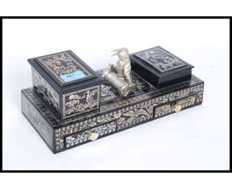 A retro mid century kitsch cigarette dispenser in black lacquer with mother of pearl style finish having kingfisher cigarette