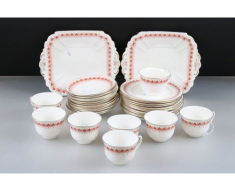 Shelley China Part Tea Service decorated with an orange geometric pattern comprising 8 tea cups, 12 saucers, 12 tea plates an