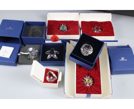 Six Boxed Swarovski items including Spiral Shell, Starfish, Christmas Hear Ornament, Heart Two Daisies and another Daisy (in 