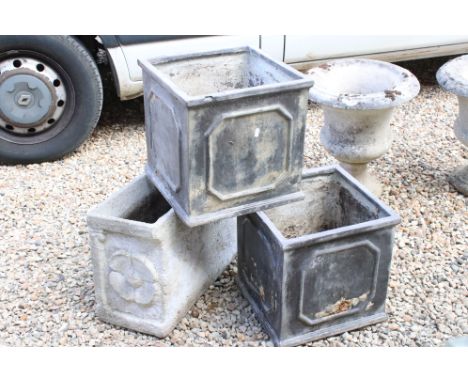 A reconstituted stone garden planter together with a pair of square garden planters. 