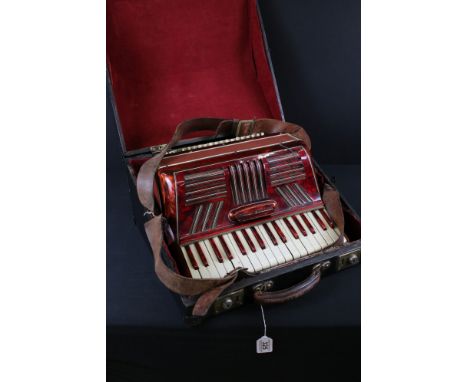 Mid 20th Century red piano accordion with leather strap, in wooden case (the accordion measures approximately 39cm wide, 36cm