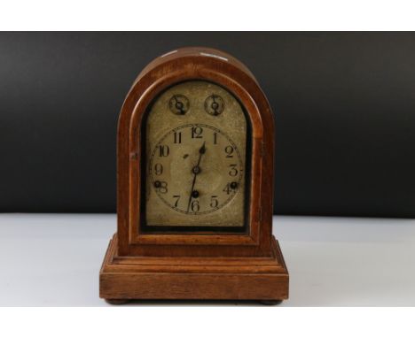 A German domed wooden cased chiming mantle clock with silvered dial, complete with key. 