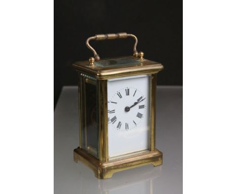 A French brass cased carriage clock with white enamel dial, complete with brass key. 