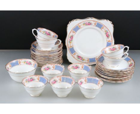 Early 20th century Tuscan China Part Tea Service decorated with flowers and blue floral panels comprising 9 tea cups, 12 sauc