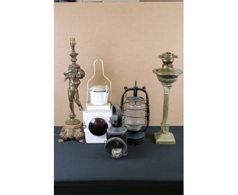 Two railway oil lamps together with a storm lantern and a brass oil lamp. 