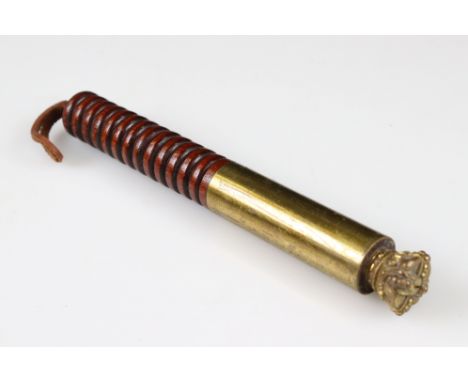 An antique brass tipstaff on turned wooden handle with crown finial. 