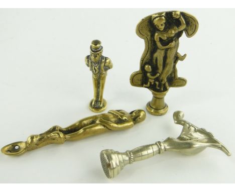 A Victorian brass erotic pipe tamp,
2.1", 2 other pipe tamps and a brass spoon modelled as a naked lady, (4).