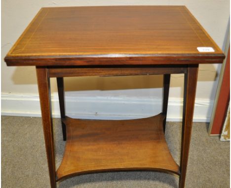 An Edwardian banded mahogany foldover card table, 
raised on square tapered legs of small size.