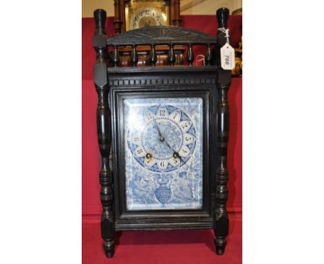 An aesthetic movement ebonised bracket clock,
with striking movement and blue and white ceramic face, height 19".