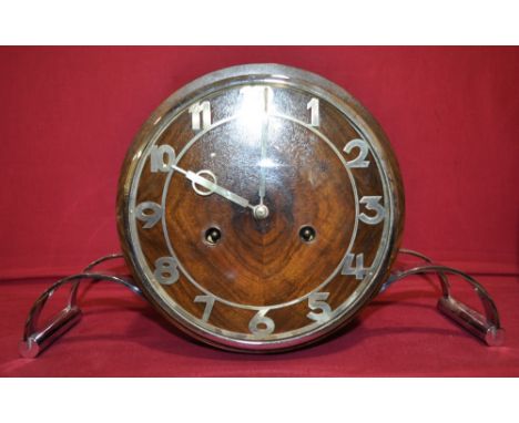 An Art Deco walnut mantle clock,
with two train movement, on shaped chrome supports, height 7.75"