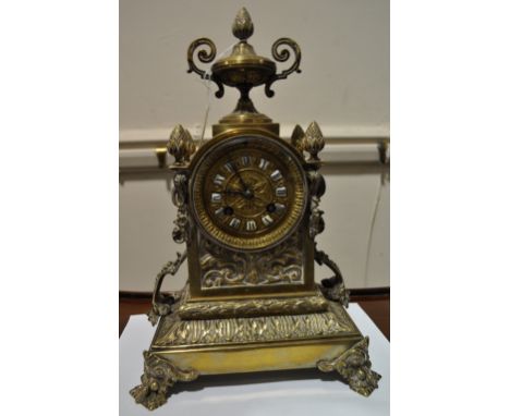 Ornate brass mantel clock,
having a 2-train bell striking movement with embossed decoration, height 13".