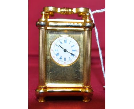 A miniature brass cased carriage clock with Corinthian columns,
height 3".