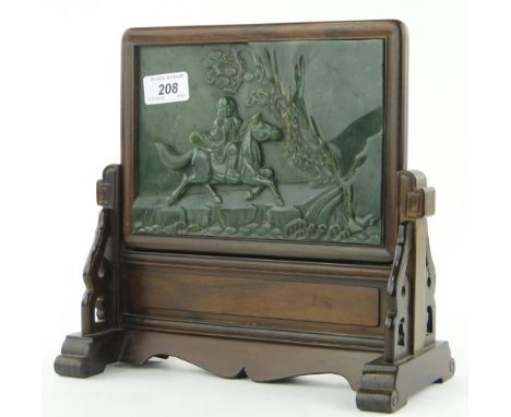 A Chinese relief-carved hardstone/jade table screen
depicting a horseman in a landscape, panel height 5.4", in carved wood st