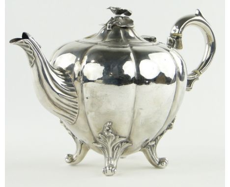 A Victorian silver melon shaped teapot
with cast floral finial, makers marks W K R, indistinct hallmarks, 22 oz.