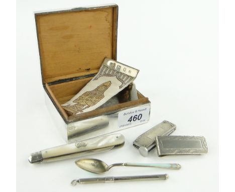 A silver cigarette box and contents,
including silver penknife, smokers knife, money clip, swizzle stick, etc.
