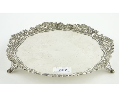A circular silver salver with cast floral surround,
indistinct hallmarks, 20 oz.