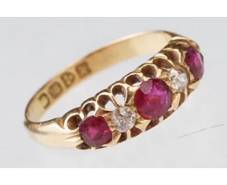 Early 20th century ruby and diamond 18ct yellow gold ring, three graduated  round mixed cut rubies, the principal ruby diamet