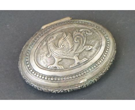 Middle Eastern / Indian white metal oval snuff box, repoussé phoenix to the centre, dimensions approx 7cm x 5cm 