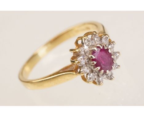 Ruby and diamond 18ct yellow gold cluster ring, oval mixed cut ruby with small round eight cut diamond surround, size of head