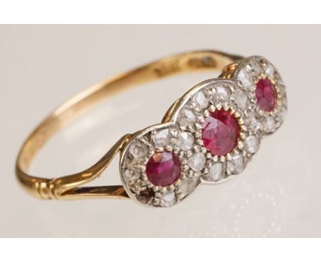 Ruby and diamond 18ct yellow gold triple cluster ring, three small round mixed cut rubies, small rose cut diamond surround, o