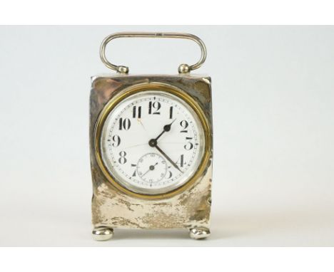 Silver carriage clock with white enamel circular dial (a/f), Arabic numerals, subsidiary seconds dial, carry handle, raised o
