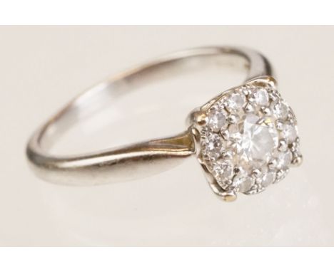 Diamond 9ct white gold cluster ring, the central round brilliant cut diamond weighing approx 0.33 carat, assessed clarity SI2