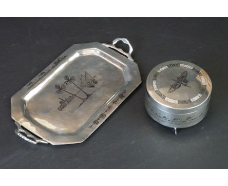 Iraqi white metal lidded trinket pot, raised on three feet, niello coastal town scenes, diameter approx 9cm; together with an