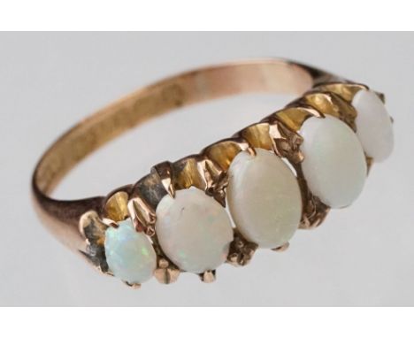 Early 20th century opal 9ct yellow gold ring, five graduated cabochon cut opals, displaying violet, green, yellow, orange and