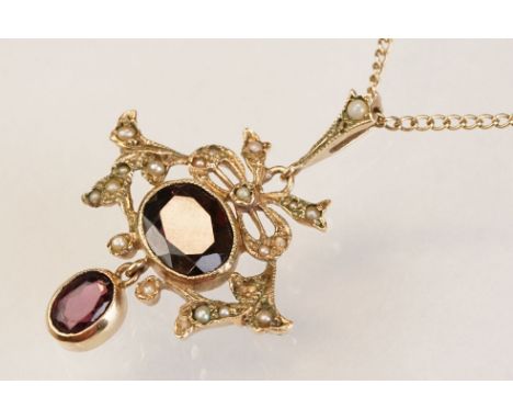 Stone set seed pearl 9ct yellow gold pendant necklace, the principal oval mixed cut stone possibly a garnet or a garnet-toppe