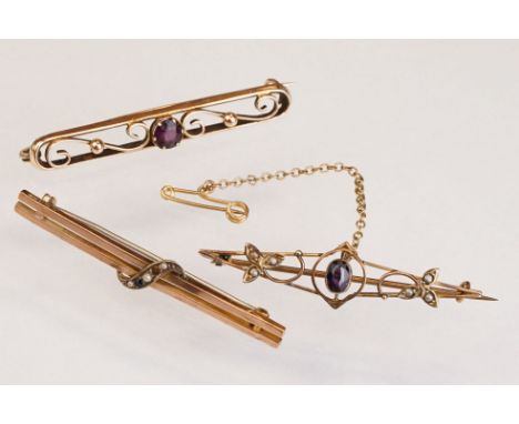 Two Edwardian 9ct bar brooches (one with missing seed pearl) together with an Edwardian yellow metal bar brooch (3) 
