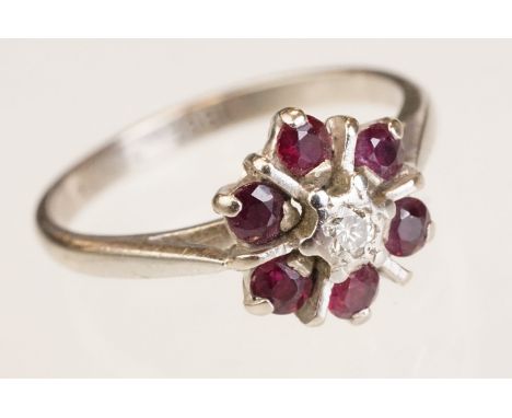 Diamond and ruby 18ct white gold cluster ring, small round brilliant cut diamond to centre, six small round mixed cut rubies,