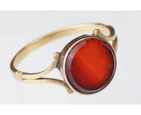 Carnelian yellow metal ring, circular carnelian panel, diameter approx 10mm, rubover set, v shaped shoulders, ring size Q½