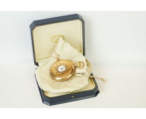 9ct yellow gold half hunter top wind pocket watch, white enamel dial and seconds dial, black Arabic numerals and poker hands,