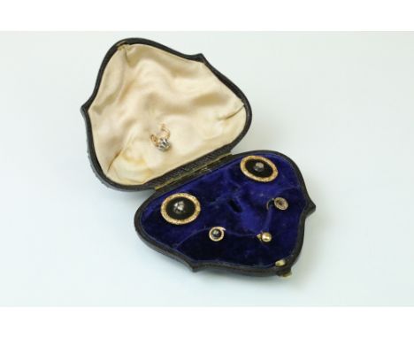 Three diamond enamelled yellow metal dress studs with cast foliate surround; another dress stud missing its enamel and diamon