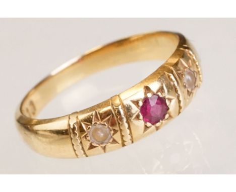 Ruby and seed pearl 18ct yellow gold ring, small round mixed cut ruby to the centre, gypsy set, ring size O 