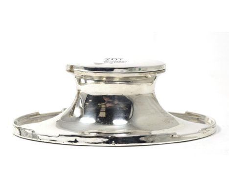 A silver capstan inkwell of oval form