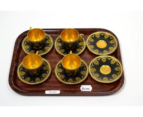 A set of four Royal Worcester black and gilt tea cups and saucers, with a further two matching saucers