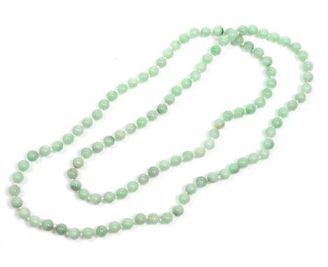A jade bead necklace, uniform beads knotted as a continuous strand, length 110cm approximately  