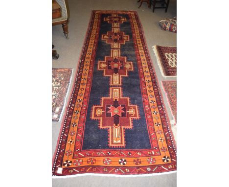 Modern Caucasian runner, centre with four cruciform lozenges on a mainly black field within a triple gull border, 390 x 110cm