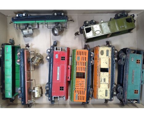 Eight Lionel O gauge wagons including two Searchlight wagons, mostly worn. (8) 