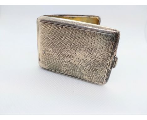 A sterling silver case.  Birmingham 1937 with engine turned decoration. 6cm wide.  31.6grms. 