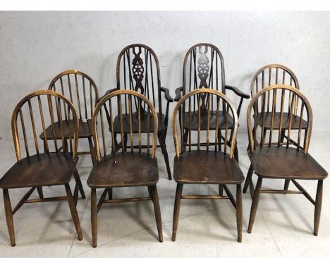 Six stick back Ercol dining chairs, and two wheel back carver chairs