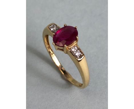 14ct Gold ring set with Oval faceted Ruby in claw setting with pair of diamonds to each shoulder size approx 'O'