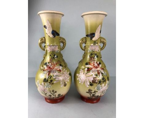 Japanese Vases, a pair of pottery vases with hand painted and enamel designs of birds and chrysanthemums, elephant side handl