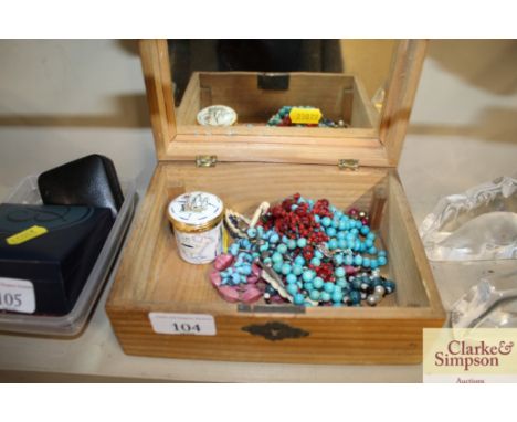 A pine trinket box and contents of various costume jewellery and an enamel hinged box 