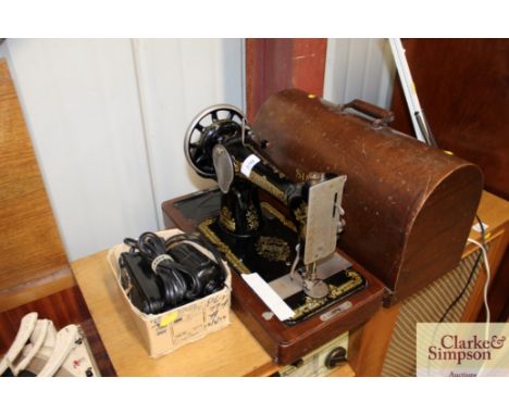 An electric Singer sewing machine in fitted case - sold as collector's item