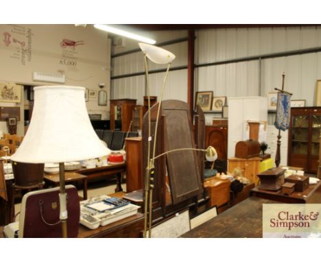 A modern brass and glass shaded uplighter with adjustable reading lamp