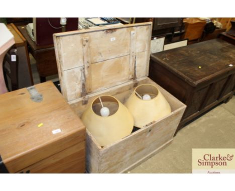 A stripped pine storage chest and contents of a pair of brass table lamps; brass candle stick; tankard; candle lantern etc