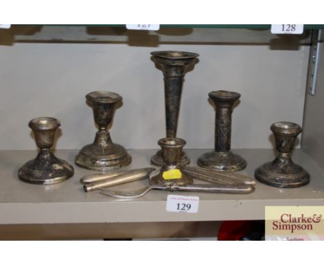 A pair of silver dwarf candlesticks; two others; a trumpet shaped spill vase; a small candlestick AF etc. 